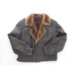 A brown leather jacket with mink lining and lapels, size 12.