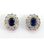 A pair of sapphire and diamond cluster ear studs, the central oval cut sapphires each 5 x 4mm, in