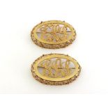 A pair of personalised brooches, each openwork oval cut with the initials 'EHS'