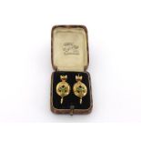 A pair of mid Victorian gold and peridot earrings, circa 1860, the oval open work drops set with a