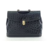 A Gianfranco Ferre briefcase in embossed crocodile patent leather with goldtone closure and key.