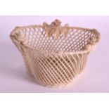 A SMALL BELEEK PORCELAIN RETICULATED BASKET encrusted with flowers. 4.5ins wide.