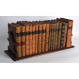 A MID VICTORIAN MAHOGANY BOOK RACK containing numerous leather bound novels & poetical works. 1Ft