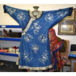 A LATE 19TH CENTURY CHINESE BLUE SILKWORK ROBE decorated with birds and foliage, the sleeves