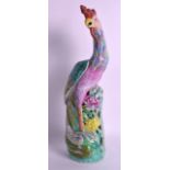 A CHINESE QING DYNASTY FAMILLE ROSE FIGURE OF A HOHO BIRD modelled in brightly coloured enamels.