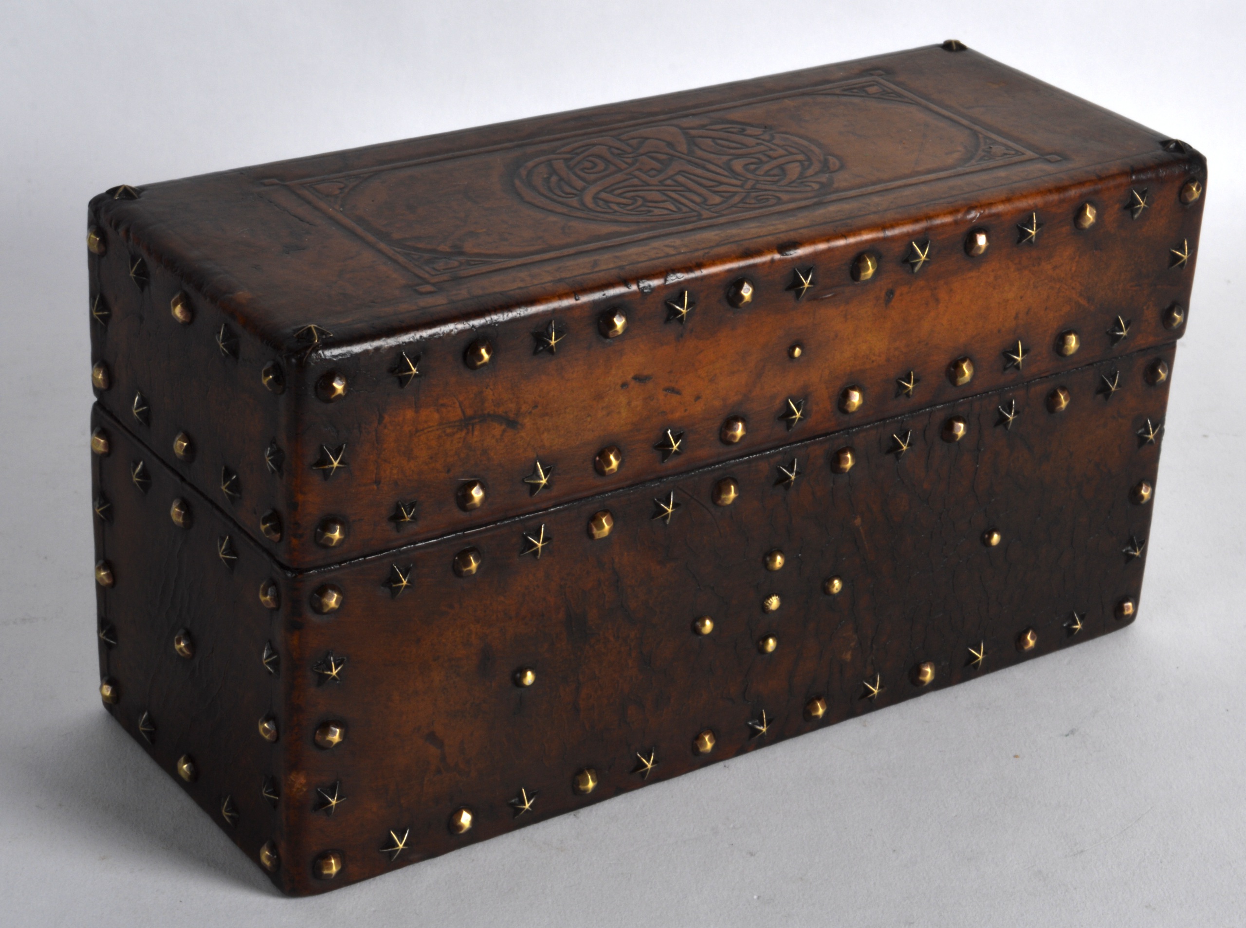 AN EARLY 20TH CENTURY TURKISH OR ISLAMIC LEATHER CASKET inset with brass stud work. 8.25ins wide.