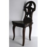 A RARE 19TH CENTURY BLACK FOREST CARVED MUSICAL CHILDS CHAIR with bear backsplat.