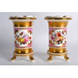 A PAIR OF MID 19TH CENTURY ENGLISH PORCELAIN VASES painted with floral sprays upon a pink ground.