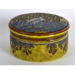 A STYLISH LONGWY POTTERY CIRCULAR BOX AND COVER enamelled with a standing stork amongst a