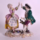 A 19TH CENTURY GERMAN PORCELAIN FIGURE OF TWO DANCERS modelled in floral painted robes. 4.75ins