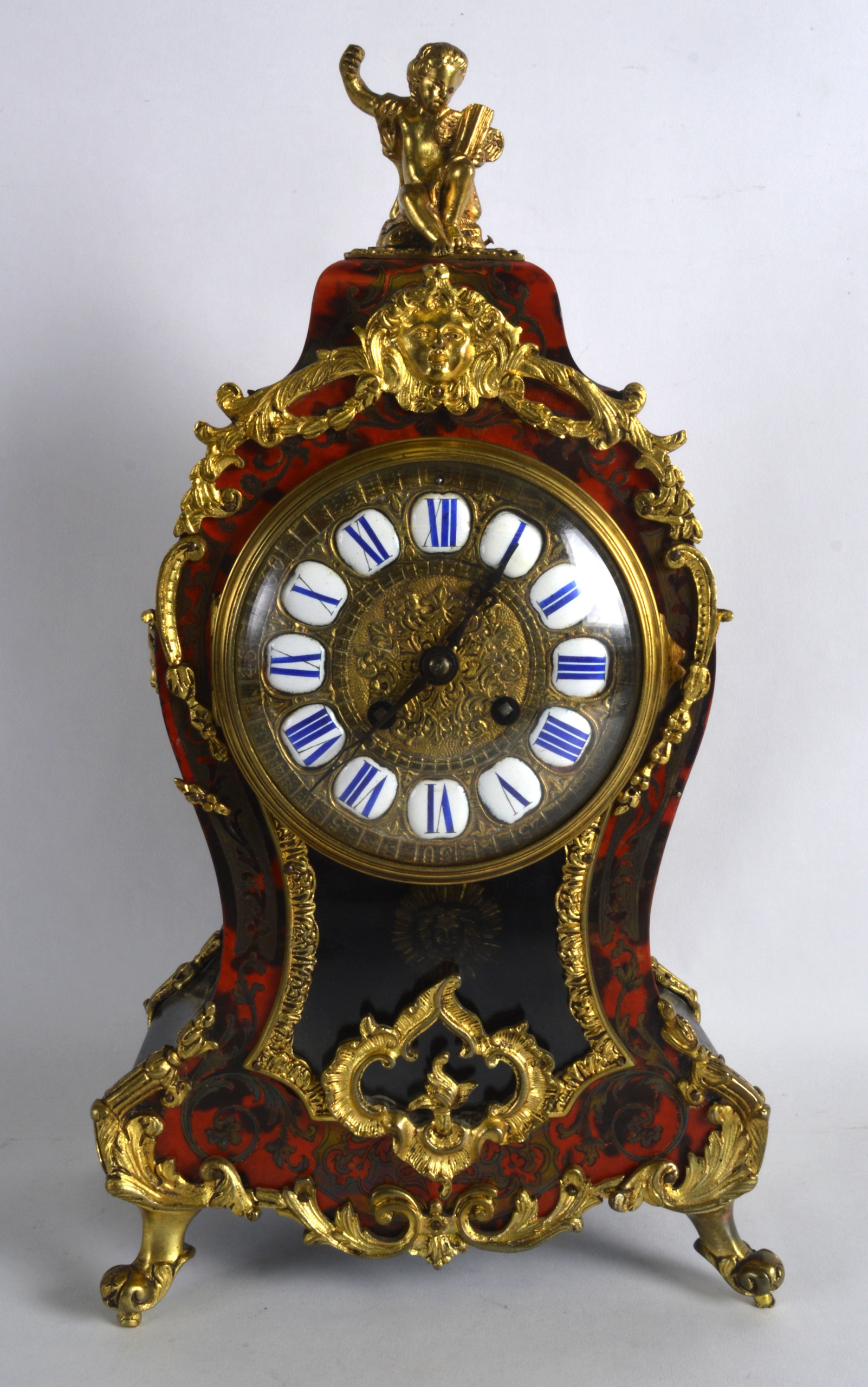 A 19TH CENTURY FRENCH BOULLE AND GILT METAL MANTEL CLOCK with cupid mounts, decorated with