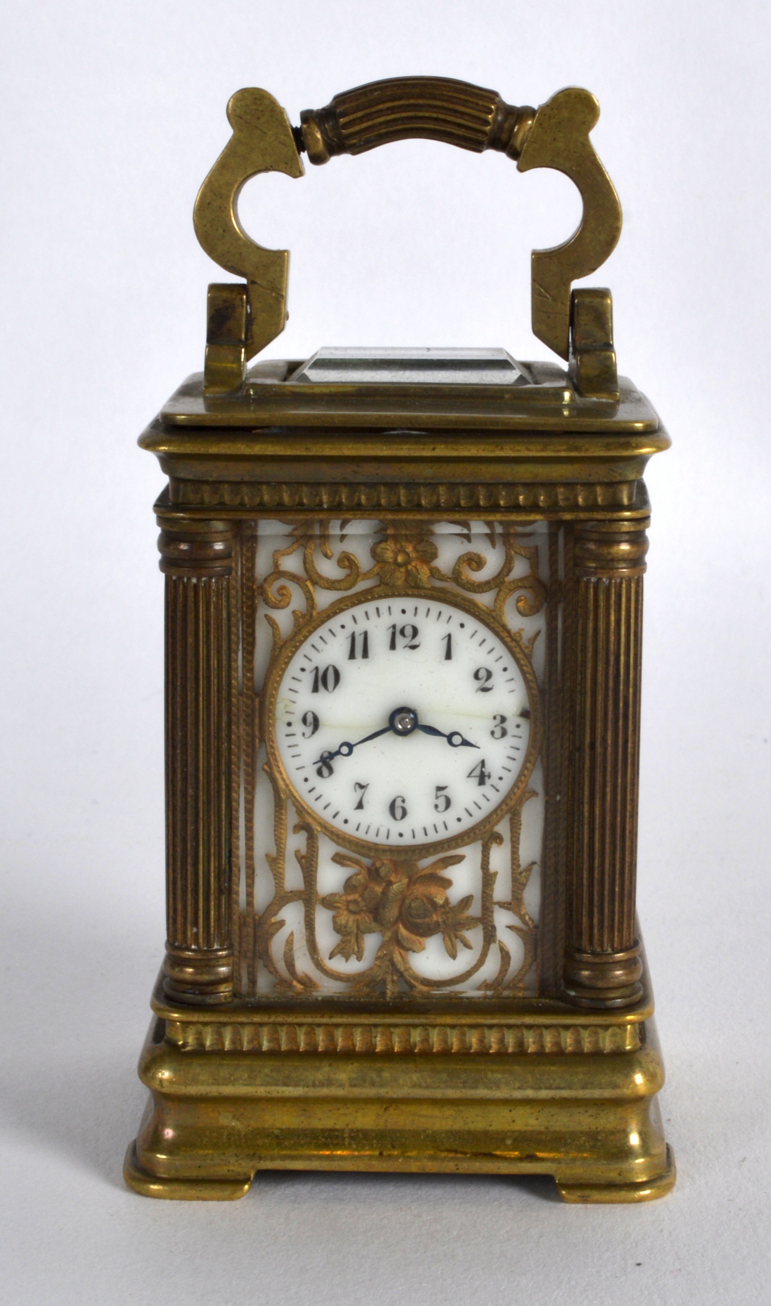 AN EARLY 20TH CENTURY FRENCH MINIATURE CARRIAGE CLOCK with white enamel dial overlaid in gilt