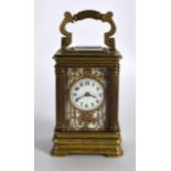 AN EARLY 20TH CENTURY FRENCH MINIATURE CARRIAGE CLOCK with white enamel dial overlaid in gilt