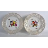 A PAIR OF EARLY 20TH CENTURY VIENNA PORCELAIN RETICULATED PLATES painted with fruit and foliage.