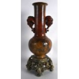 A GOOD 19TH CENTURY CHINESE CARVED SOAPSTONE VASE with twin elephant mask head handles, decorated