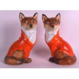 AN EXTREMELY RARE PAIR OF ROYAL BAYREUTH HUNTING FOX CANDLESTICKS each modelled in hunting attire,