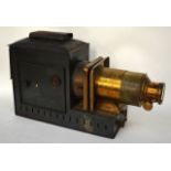 A VICTORIAN MAGIC LANTERN with brass lens. 1Ft 8ins wide.