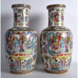 A LOVELY PAIR OF MID 19TH CENTURY CHINESE CANTON FAMILLE ROSE ROULEAU VASES painted with figures