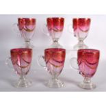 A SET OF SIX BOHEMIAN RED AND CLEAR GLASS CUPS highlighted in gilt with swags and vines. 4.25ins