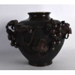 A LATE 19TH CENTURY JAPANESE MEIJI PERIOD BRONZE VASE overlaid with berries, vines and flowers.