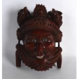 AN EARLY 20TH CENTURY CHINESE CARVED HARDWOOD MASK with glass eyes, in the form of a bearded male.