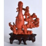 A RARE LATE 19TH CENTURY CHINESE CARVED RED CORAL SNUFF BOTTLE AND STOPPER formed with two figures