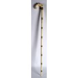 A LATE 19TH CENTURY CARVED IVORY ELEPHANT WALKING CANE with horn handing to the central banding. 3Ft