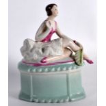 AN ART DECO GERMAN PORCELAIN TRINKET BOX AND COVER modelled as a female holding a fan. 5Ins high.