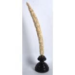 A 19TH CENTURY AFRICAN CARVED LOANGO IVORY TUSK decorated with several figures in various