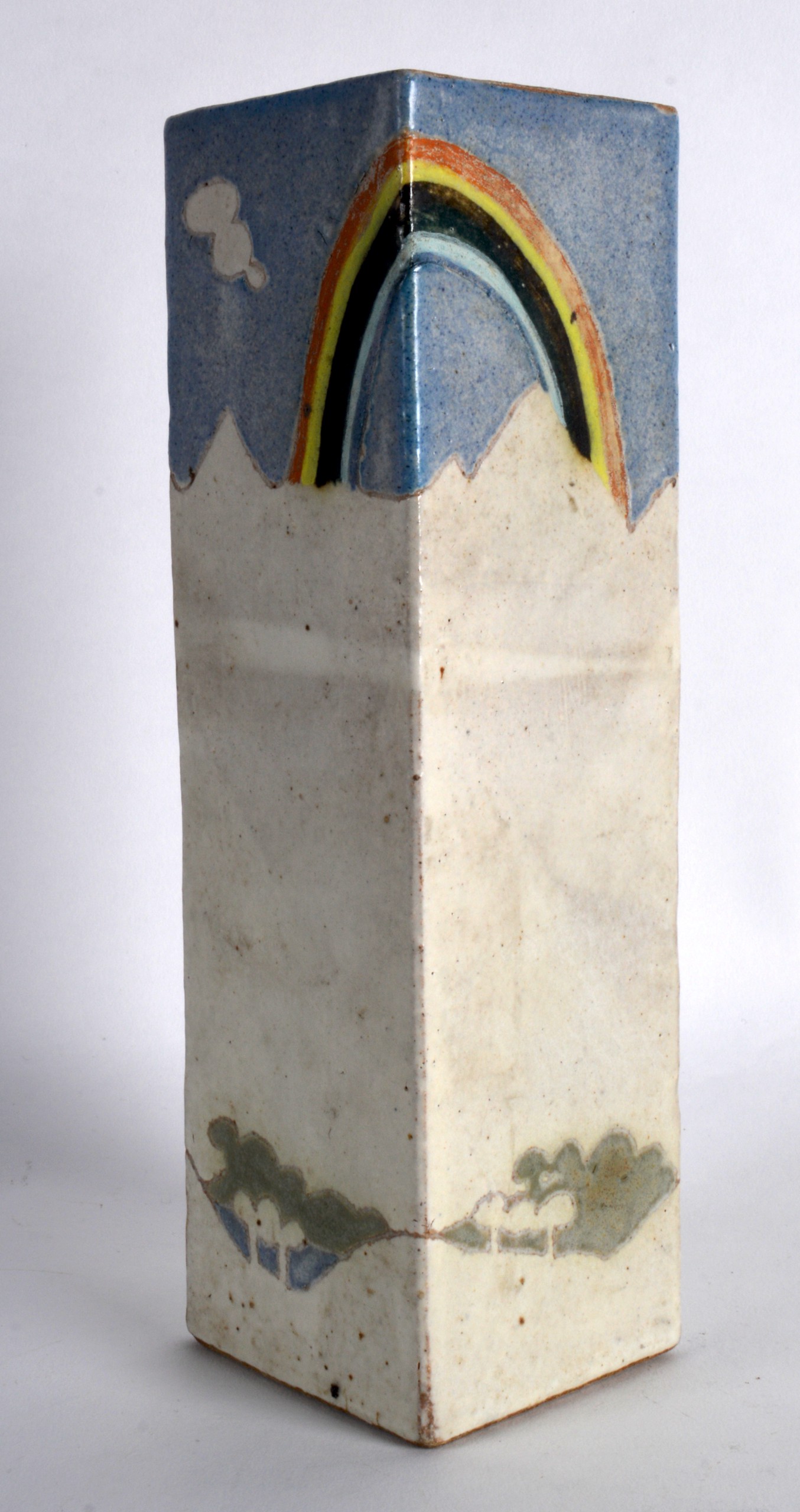 AN UNUSUAL STUDIO POTTERY SQUARE FORM BRUSH POT decorated with a rainbow and landscape. Signed. 9.