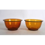 A PAIR OF EARLY 20TH CENTURY CHINESE PEKING AMBER GLASS BOWLS. 4Ins diameter.