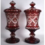 A FINE PAIR OF VERY LARGE BOHEMIAN RUBY GLASS GOBLETS AND COVERS engraved all over with ducks upon