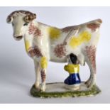 AN EARLY 19TH CENTURY STAFFORDSHIRE POTTERY CREAMER in the form of a standing cow with an