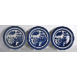 A SET OF THREE EARLY 19TH CENTURY ENGLISH BLUE AND WHITE PLATES decorated with a Willow type