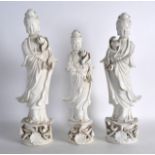 A PAIR OF EARLY 20TH CENTURY CHINESE BLANC DE CHINE FIGURES OF GUANYIN together with a smaller