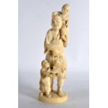 A 19TH CENTURY JAPANESE MEIJI PERIOD CARVED IVORY OKIMONO depicted as a male holding a fish, with