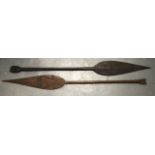 A PAIR OF EARLY 20TH CENTURY NIGERIAN CARVED WOOD PADDLES carved with curving motifs. 4Ft 8ins