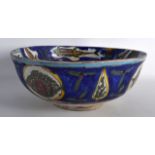 A LARGE PERSIAN POTTERY BOWL painted with fish and birds upon a blue ground. 12.25ins diameter.