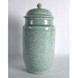 A GOOD CHINESE GREEN CELADON CYLINDRICAL JAR AND COVER bearing Qianlong marks to base, decorated