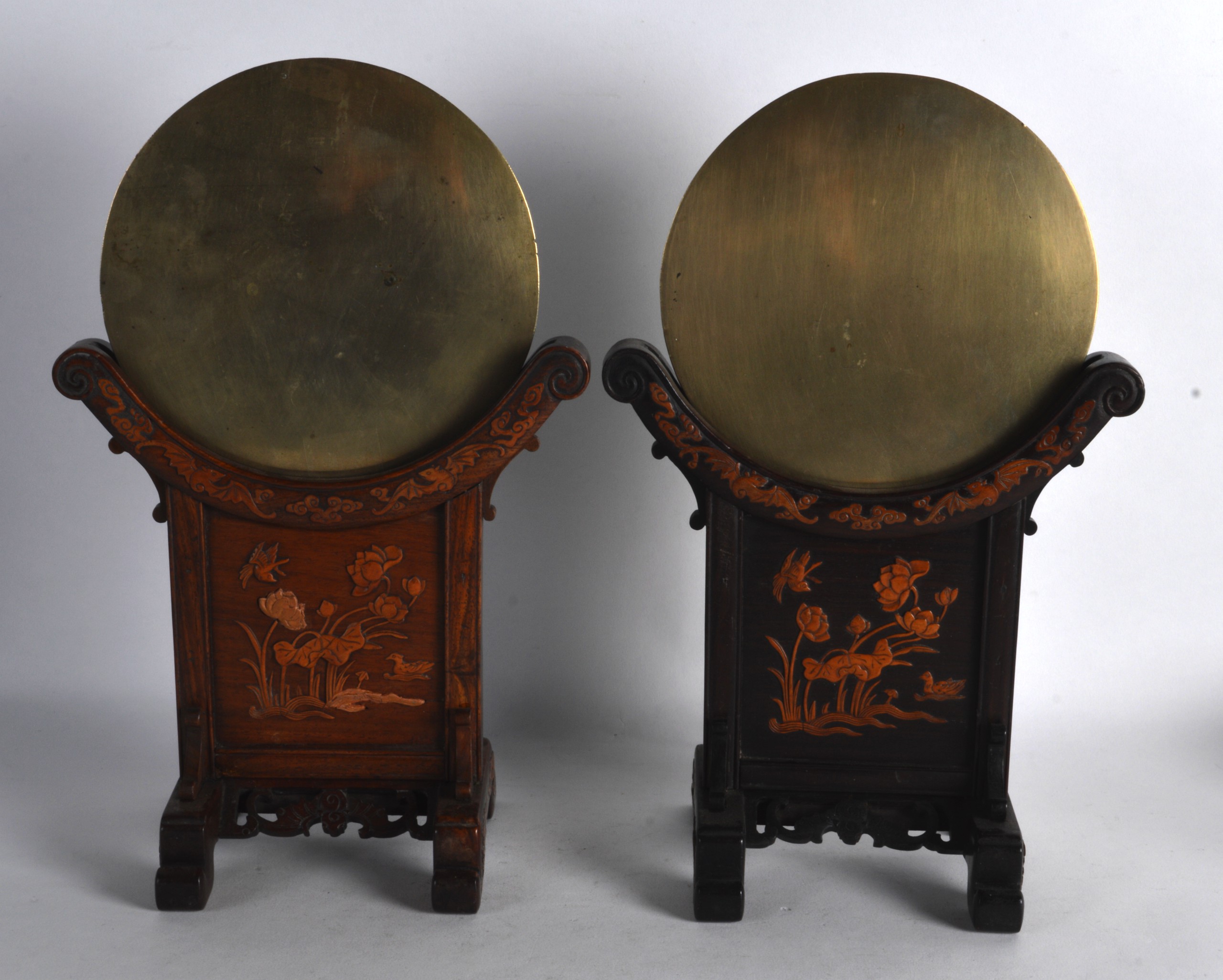 A GOOD PAIR OF 19TH CENTURY CHINESE HARDWOOD AND BOXWOOD MIRRORS ON STANDS decorated with birds