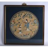 A FRAMED 19TH CENTURY CHINESE CIRCULAR SILK ROUNDEL depicting two females and a child within a
