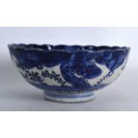 A LATE 19TH CENTURY JAPANESE MEIJI PERIOD BLUE AND WHITE SCALLOPED BOWL painted with landscapes.