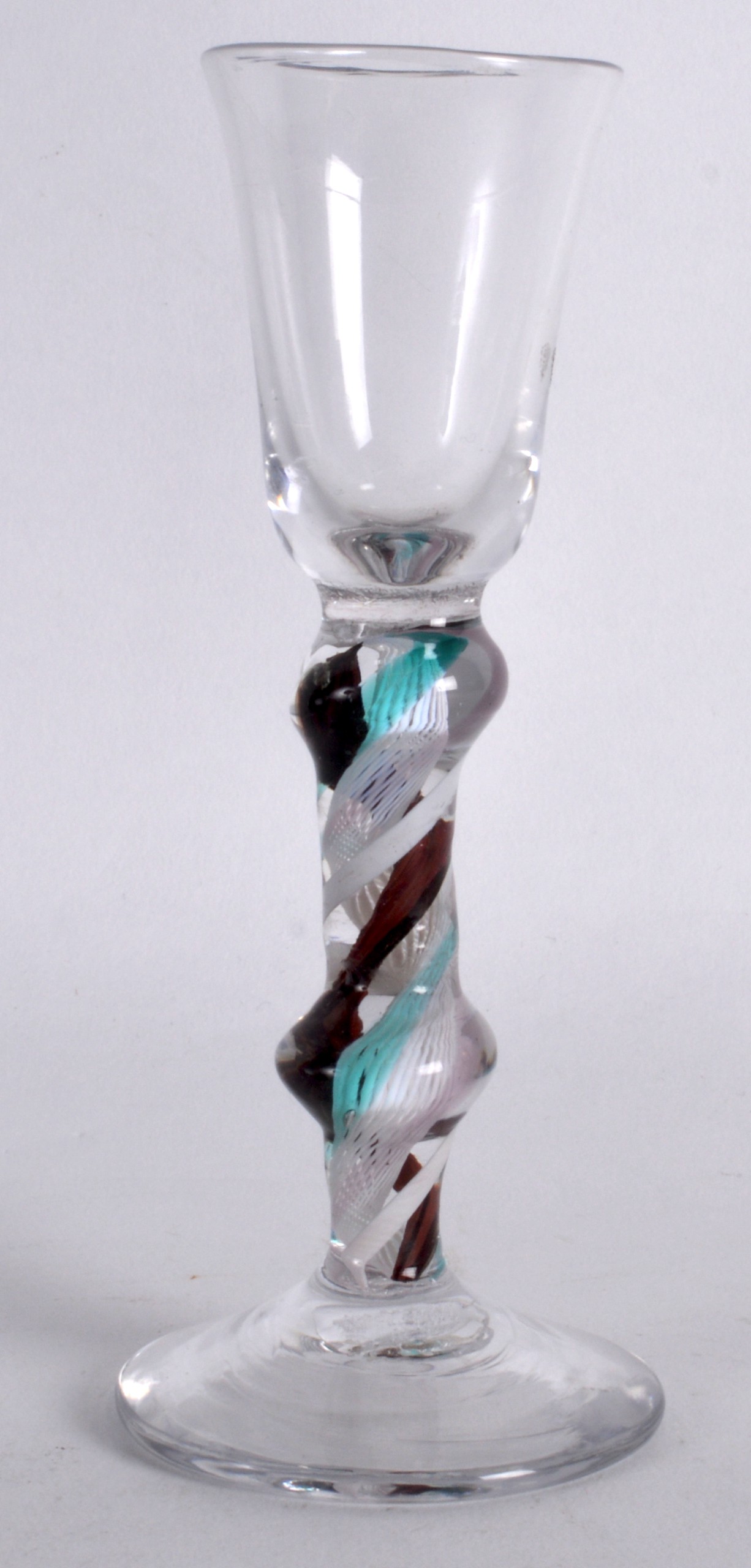 A 19TH CENTURY MULTI COLOURED SPIRAL TWIST GLASS upon a circular foot. 5.75ins high.