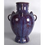 A CHINESE TWIN HANDLED FLAMBE GLAZED PORCELAIN VASE bearing Qianlong marks to base, with sparse