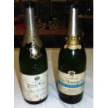 A MATCHED PAIR OF VINTAGE EMPTY JEROBOAM CHAMPAGNE BOTTLES. 1 ft 7ins high.