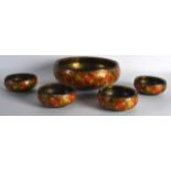 AN EASTERN LACQUERED FLORAL BOWL together with four matching bowls. Largest 9ins diameter. (5)