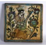 A PERSIAN SQUARE FORM POTTERY TILE painted with a female musician within a landscape. 9.5ins