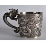 A 19TH CENTURY CHINESE EXPORT SILVER CUP with finely formed dragon handle, decorated in relief