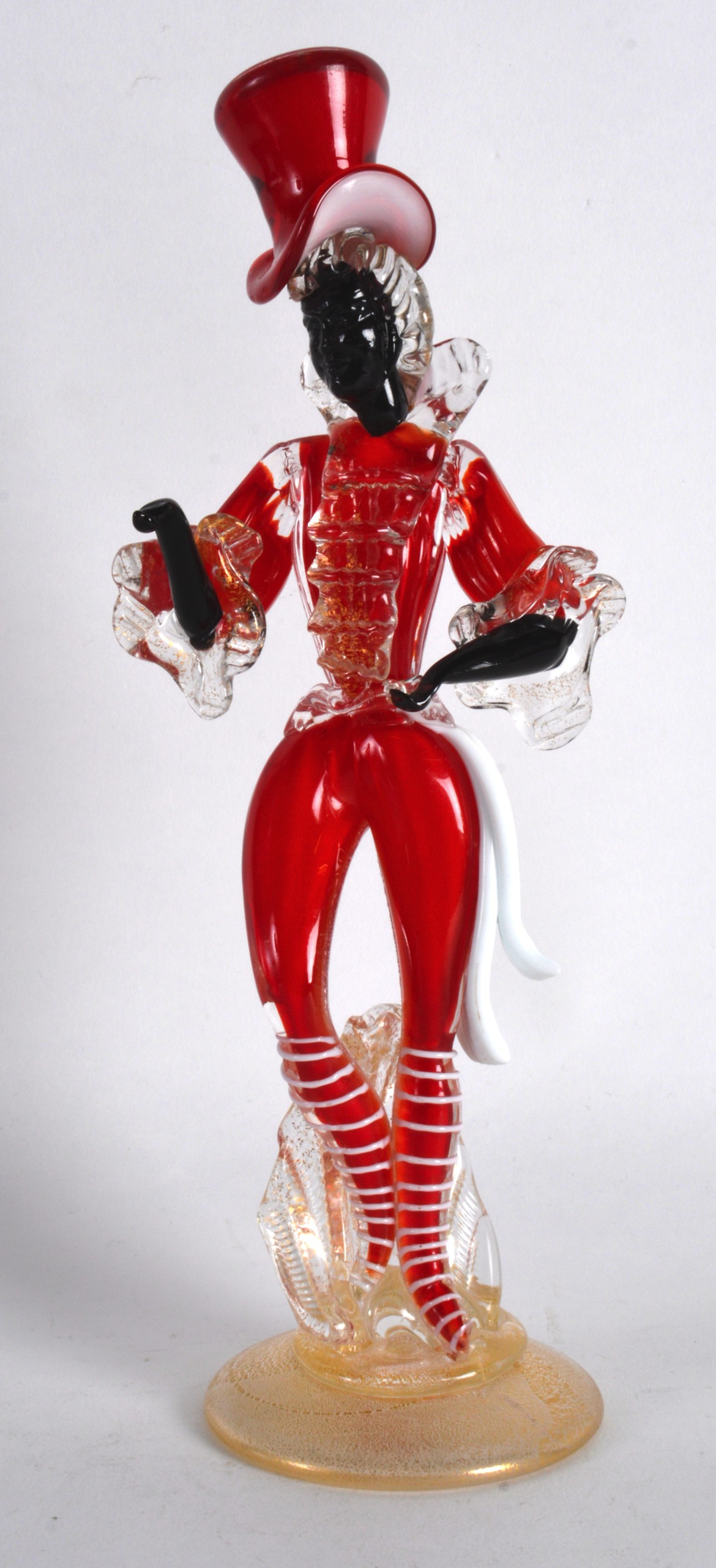 AN UNUSUAL VENETIAN RED AND WHITE GLASS FIGURE modelled wearing a top hat, upon a gilt splashed