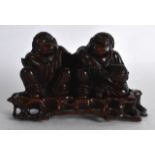AN EARLY 20TH CENTURY CHINESE CARVED HARDWOOD FIGURE depicting the he he erxian twins. 4.5ins wide.